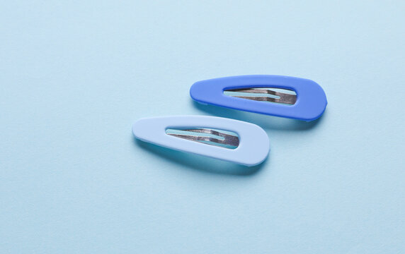 Hair clips on blue pastel background. Top view. Hair accessories, Beauty concept