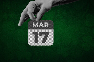 St Patrick day March 17th Calendar Page. Halftone collage of a hand holding a calendar page with the words March 17