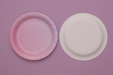 Paper disposable plates for birthday party on purple background
