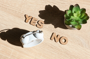 Words yes and no on the table with office accessories. Business concept. Top view