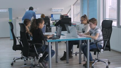 Primary school children studying on laptops in a modern classroom during STEM lessons