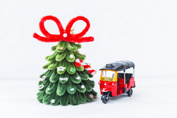 Tuk Tuk taxi and Christmas tree on white background, welcome holiday to Thailand, travel to Asia, Christmas card background idea
