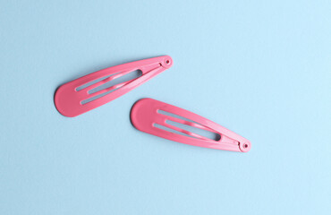 Hair clips on a blue background. Beauty concept