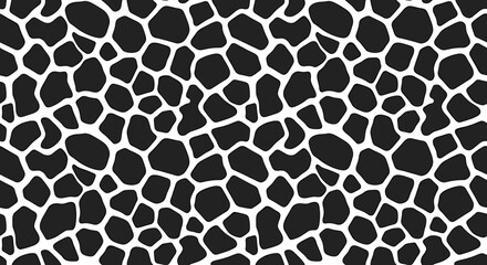 Close-up of a black and white giraffe print pattern on a flat surface with a shallow depth of field and a neutral mood against a clean white background.