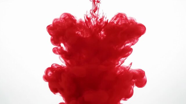 Dramatic 4K Slow Motion of Red Liquid Dye Exploding and Spreading to Create an Abstract Cloud in Clear Water on a White Background