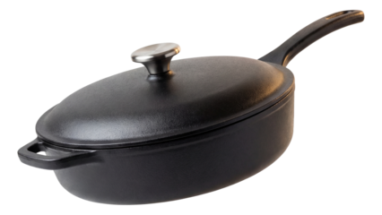 A heavy cast iron saute pan with a lid, perfect for slow-cooking stews in a cozy cottage.