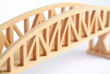Wooden isometric design bridge structure made of light balsa wood on white surface