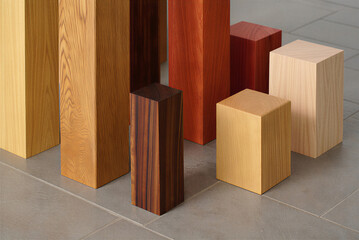 Wooden isometric design set of pillars of varying wood species on gray stone floor
