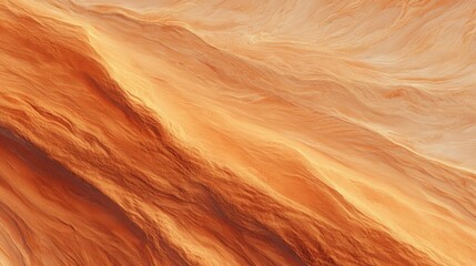 Obraz premium Top view of desert sand dunes with natural wind patterns and golden orange texture