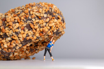 Fitness Woman Struggling Under Giant Donut Concept