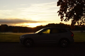 Stunning orange and pink sunset over the Swedish countryside with fields and forests 