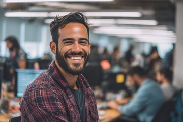 Diverse hispanic tech male worker in open space office or coworking space wearing casual clothes, laughing with colleagues, candid collaboration moment
