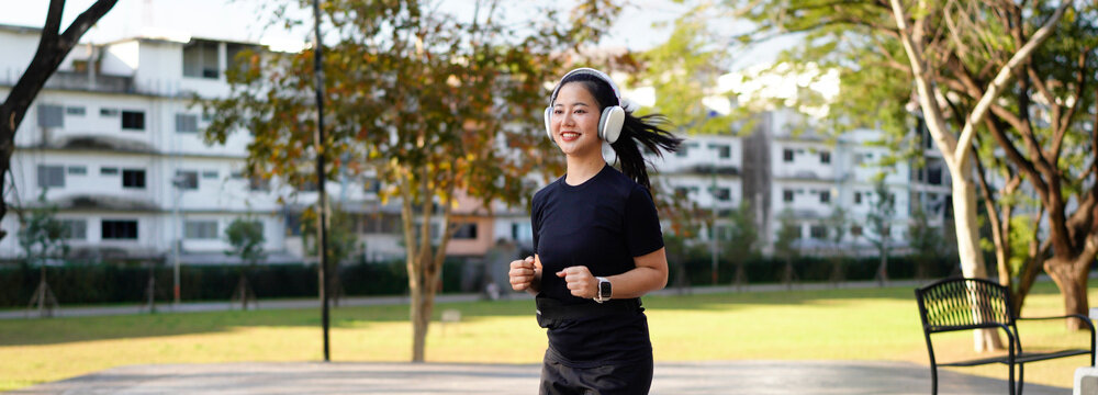 Beautiful asian fitness female sportswoman runner doing morning jogging exercise training outdoor.