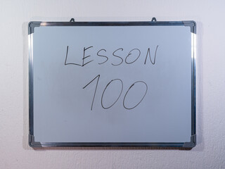 Whiteboard showing LESSON concept representing advanced learning stage and long term educational progress