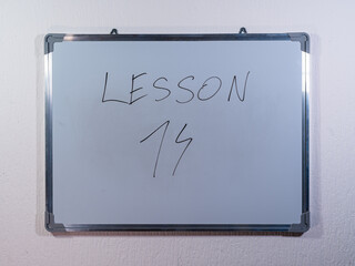 Whiteboard showing LESSON concept on minimal background representing education stages and learning journey