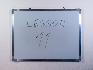 Whiteboard showing LESSON concept on minimal background representing education stages and learning journey