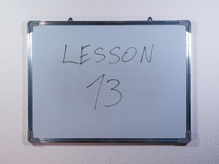 Whiteboard showing LESSON concept on minimal background representing education stages and learning journey