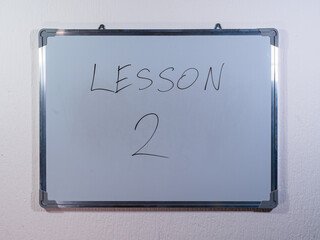 Whiteboard showing numbered LESSON concept representing structured learning and educational progress
