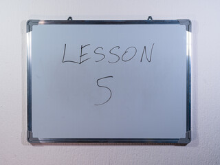 Whiteboard showing LESSON message representing knowledge transfer, training and skill development