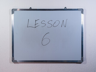 Whiteboard showing LESSON message representing knowledge transfer, training and skill development