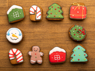 Decorated Christmas gingerbread cookies frame on wood