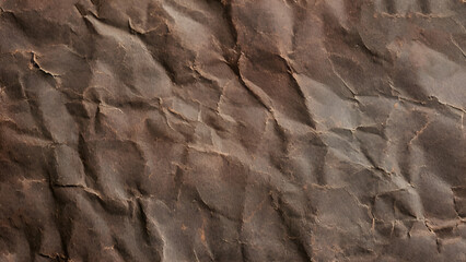 Fototapeta premium Crinkled brown paper texture in natural light setting for crafts. Old vintage crumpled paper