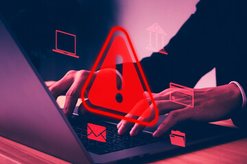 Cyber security alert concept showing hacker hands using laptop with red warning sign, system hack notification, data breach risk, digital attack, network protection, online privacy threat
