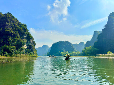Blue Ngo Dong river winding at the foot of limestone mountains in Tam Coc. The majestic beauty of nature at Tam Coc - Bich Dong in the Trang An Landscape Complex - Ninh Binh, Vietnam