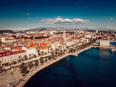 Aerial view of the Diocletian's Palace standing proudly with its bell tower, the Riva promenade bustling with life against the deep blue Adriatic, Split, Split-Dalmatia County, Croatia.