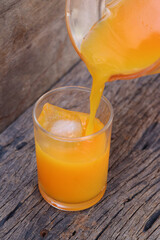 Soft drinks orange juice and iced in glass
