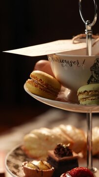 A tray of pastries and a cup with a sign that says "Laurel.". The pastries are arranged on a white plate and the cup is on top of a white plate