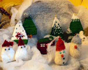 Christmas decorations from various knitted items, gnomes, snowmen, trees and houses, beautiful card, festive mood