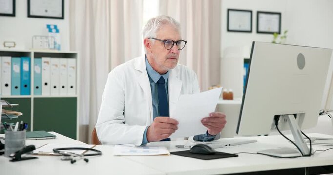 Doctor, man and computer in office with paperwork for health insurance, patient report or research. Healthcare worker, mature person or reading in clinic with desktop, medical aid document or review.