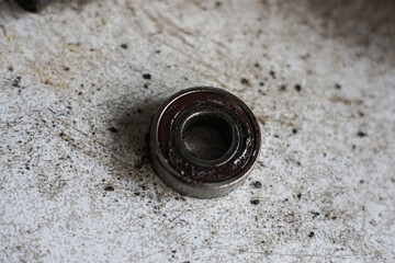 Old rusty metal ball bearing on dirty background mechanical engine part replacement
