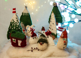 Christmas decorations from various knitted items, gnomes, snowmen, trees and houses, beautiful card, festive mood