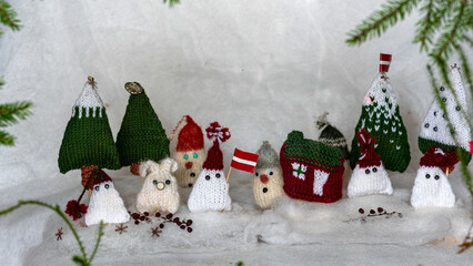 Christmas decorations from various knitted items, gnomes, snowmen, trees and houses, beautiful card, festive mood