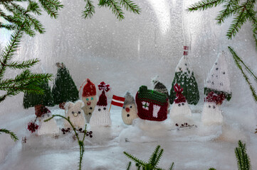 Christmas decorations from various knitted items, gnomes, snowmen, trees and houses, beautiful card, festive mood