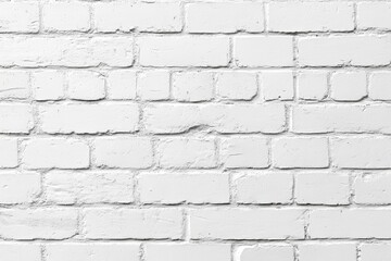 Obraz premium A plain white brick wall, featuring a textured surface with subtle variations in color and pattern.