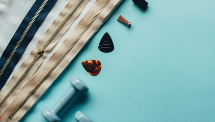 Fitness equipment and accessories arranged on a blue background with a yoga mat