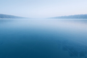 Fototapeta premium Deep blue frozen ice creating a tranquil and minimal winter landscape