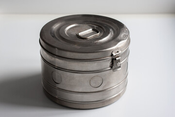 An old medical box is on a white table. Horizontal shot.