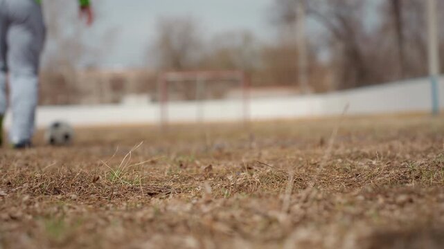 quick soccer dash, fastpaced run toward goal in training, athlete sprints with ball across rugged playing surface, dynamic action shot of player speeding towards goal during rigorous practice