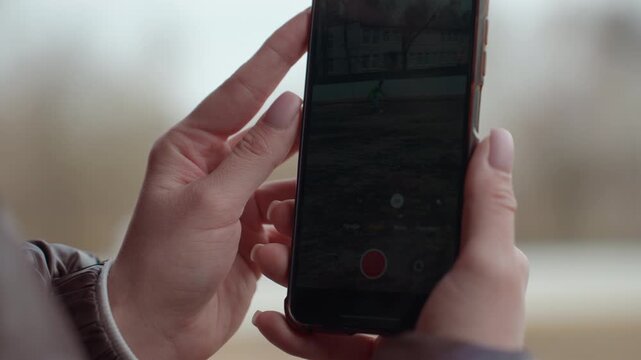 carefully arranging phone display outdoors, fingertip touches visualize preview mode outdoors carefully, creative arrangement of phone screen frame outdoors under soft muted lighting conditions
