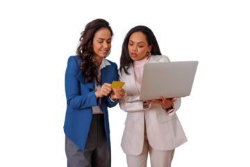 Two businesswomen collaborating on an online purchase, holding a credit card and using a laptop, showing teamwork