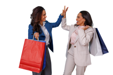 Two smiling women friends giving a high five, expressing joy and success while holding assorted shopping bags, on a transparent background