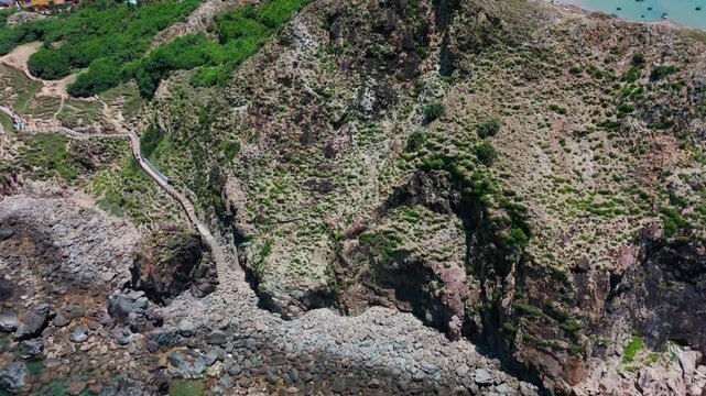 Dramatic Close-Up Aerial Drone View of Rugged Eo Gio Volcanic Cliffs and Coastal Hiking Trail, Quy Nhon, Binh Dinh Province, Central Vietnam, Southeast Asia