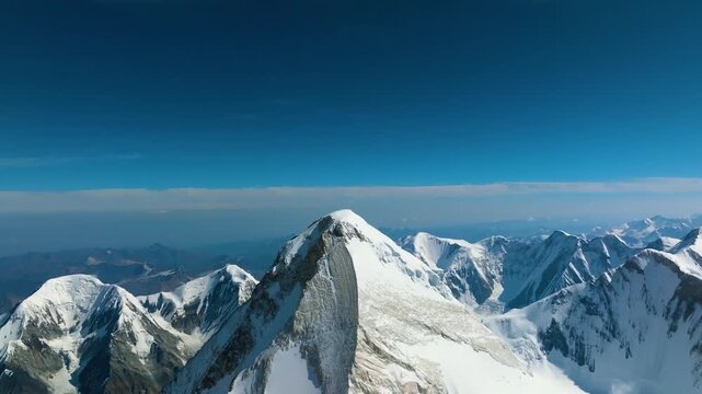 Glacier and snowy mountain drone view. Aerial shot of Khan Tengri Peak. Kyrgyzstan. Tian Shan mountains and awesome landscape. 4K