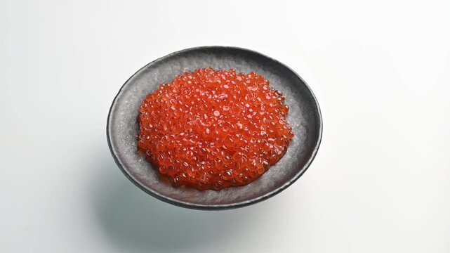 Fresh fish roe served in a small bowl at a dining table ready for enjoyment