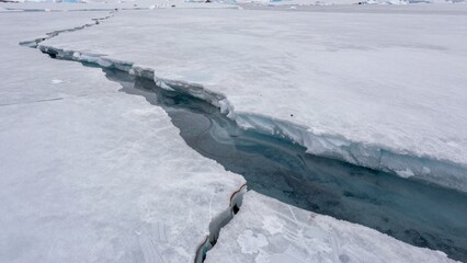 Crack forms in Arctic ice as temperatures change and climate shifts observed in winter months
