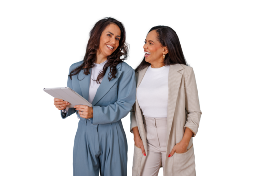 Two diverse businesswomen smiling and interacting, one holding a tablet, representing professional collaboration and female empowerment - Powered by Adobe
